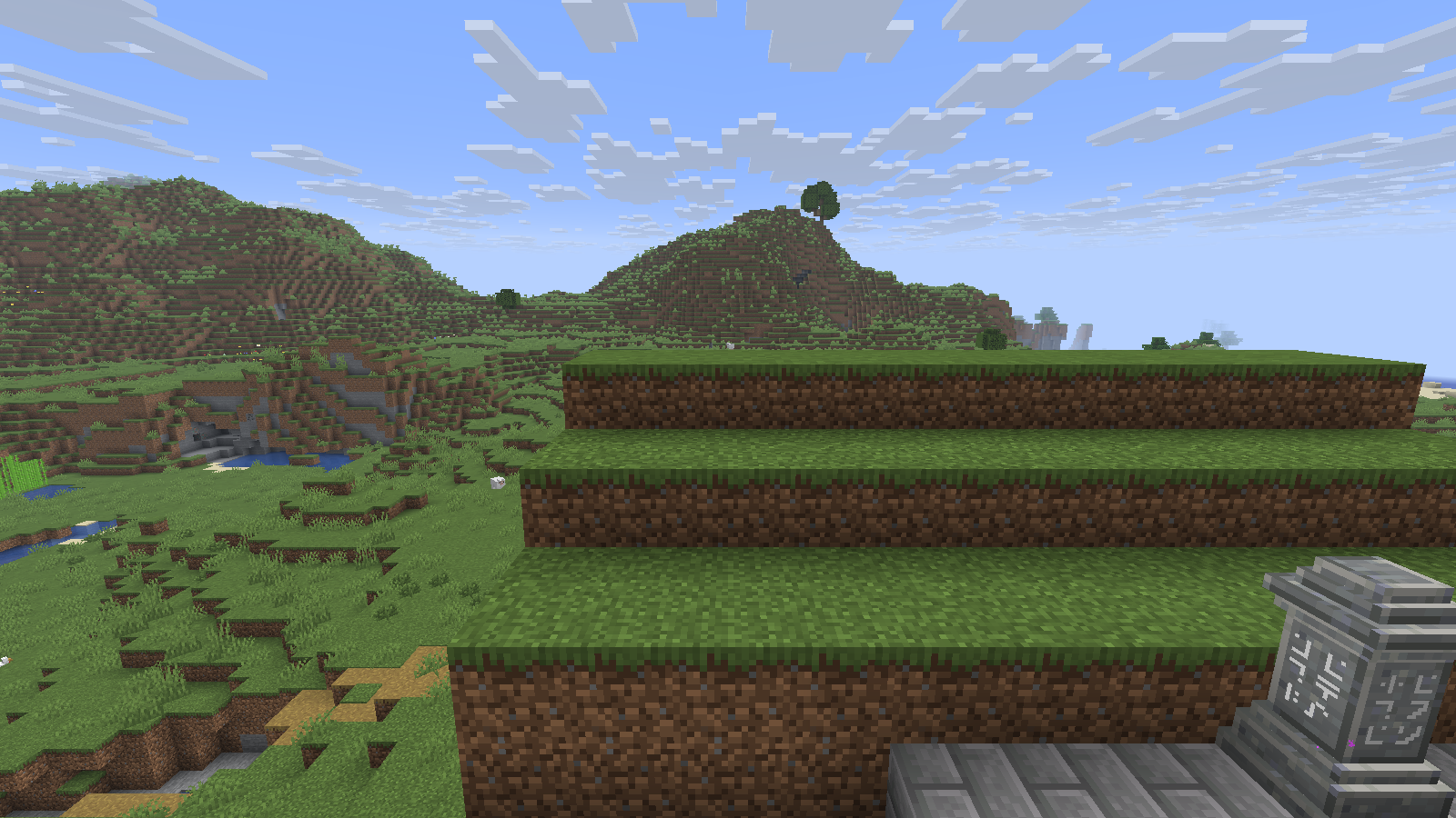 Default grass terraces show brown dirt sides beneath their green tops.