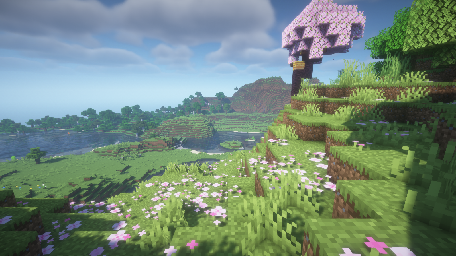 BSL renders the cherry hillside with bright grass, soft clouds and shaded ground under the trees.