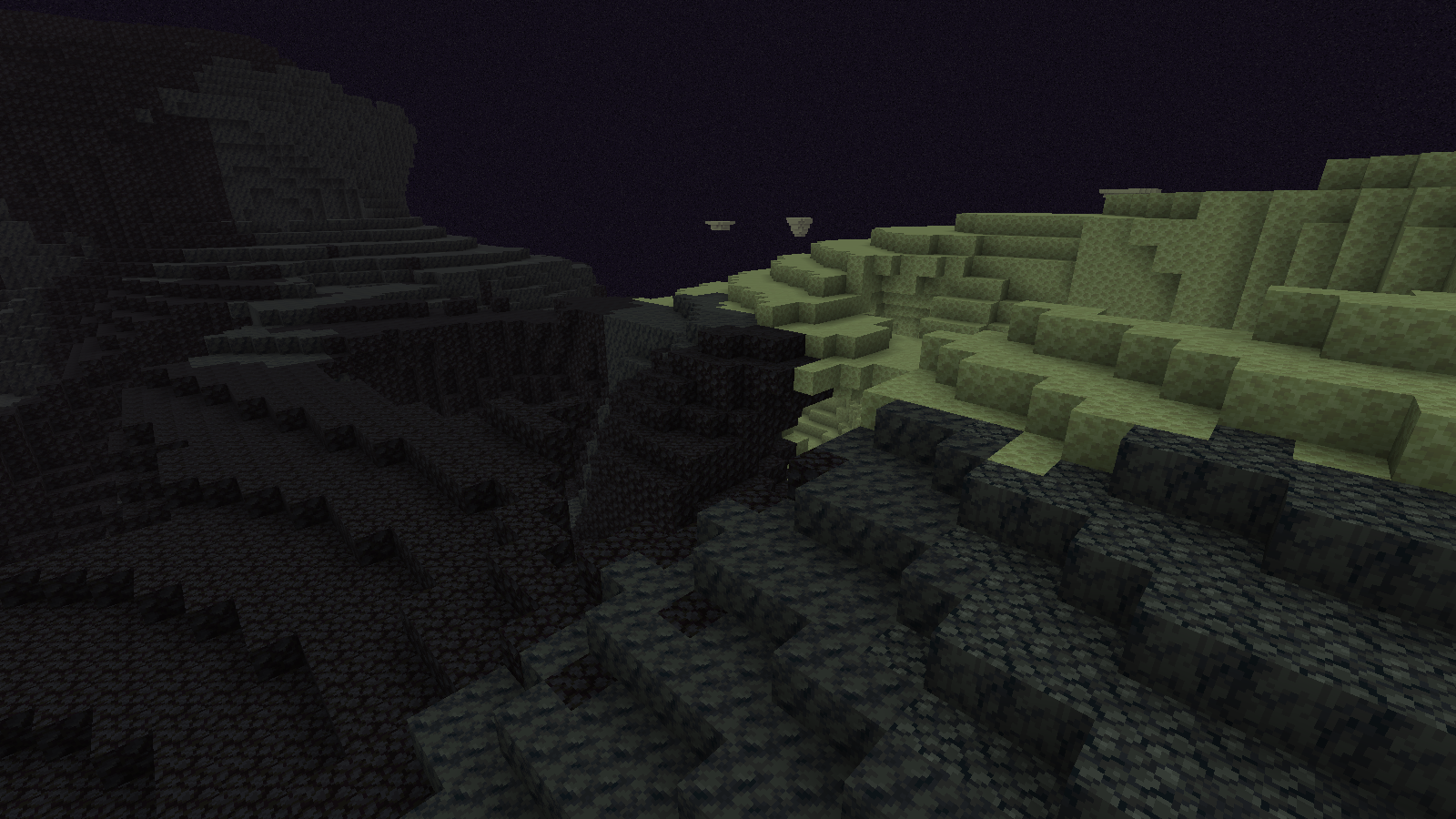 A lower island edge where dark stepped terrain meets a pale end-stone ledge across a gap.