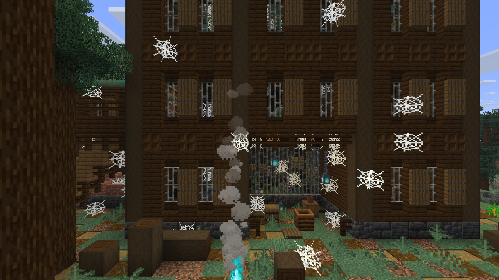 Cobwebs, iron bars, soul lanterns and a blue campfire frame the old manor entrance.