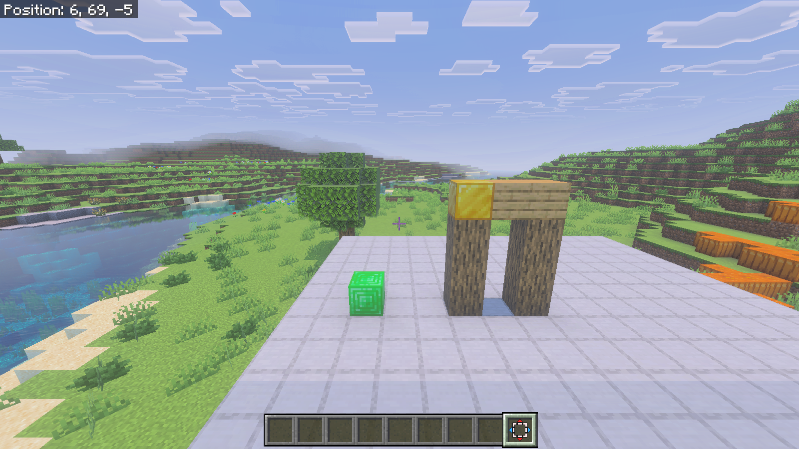 The restored arch stands to the right of the emerald block, viewed from the fixed comparison camera.