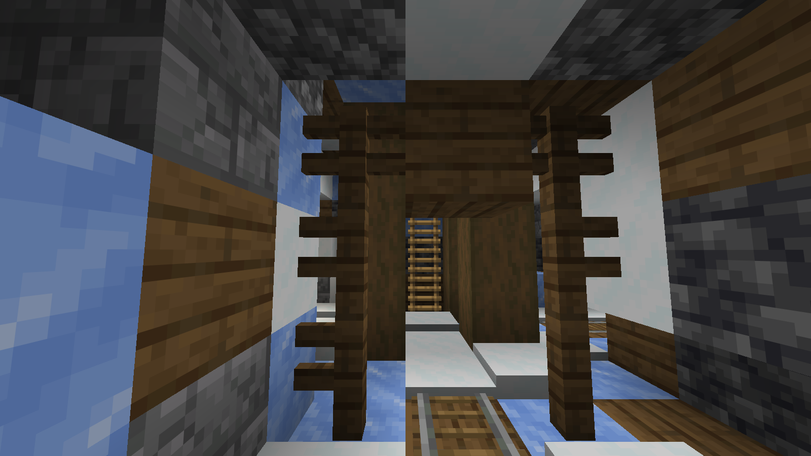 Rails meet a ladder at a compact junction, showing how this mineshaft links passages vertically as well as horizontally.