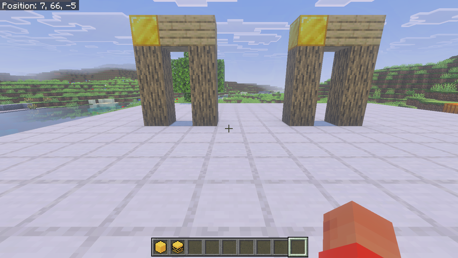 Two matching oak-log arches with gold corners stand side by side on the platform.