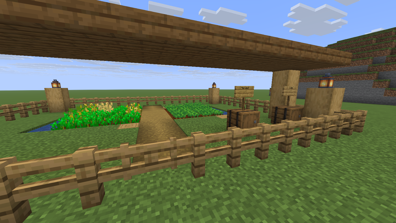 Labeled supply barrels sit beside the garden gate. Java 26.2 demonstration garden.