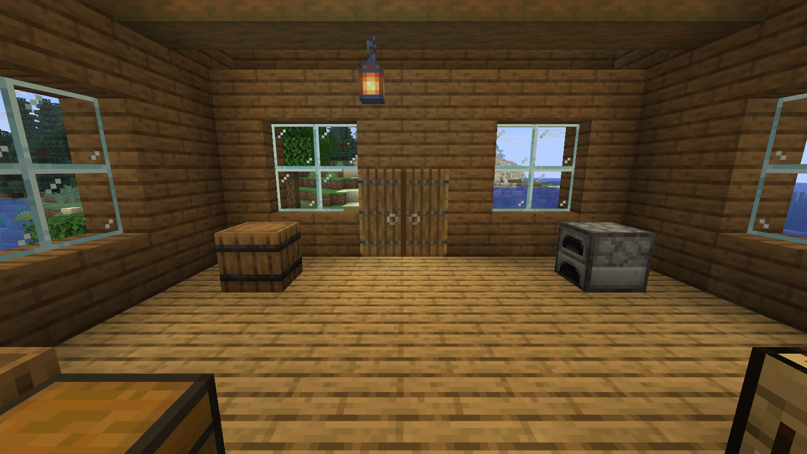 Two complete spruce doors sit beneath a solid timber header; the cabin includes a barrel and furnace.