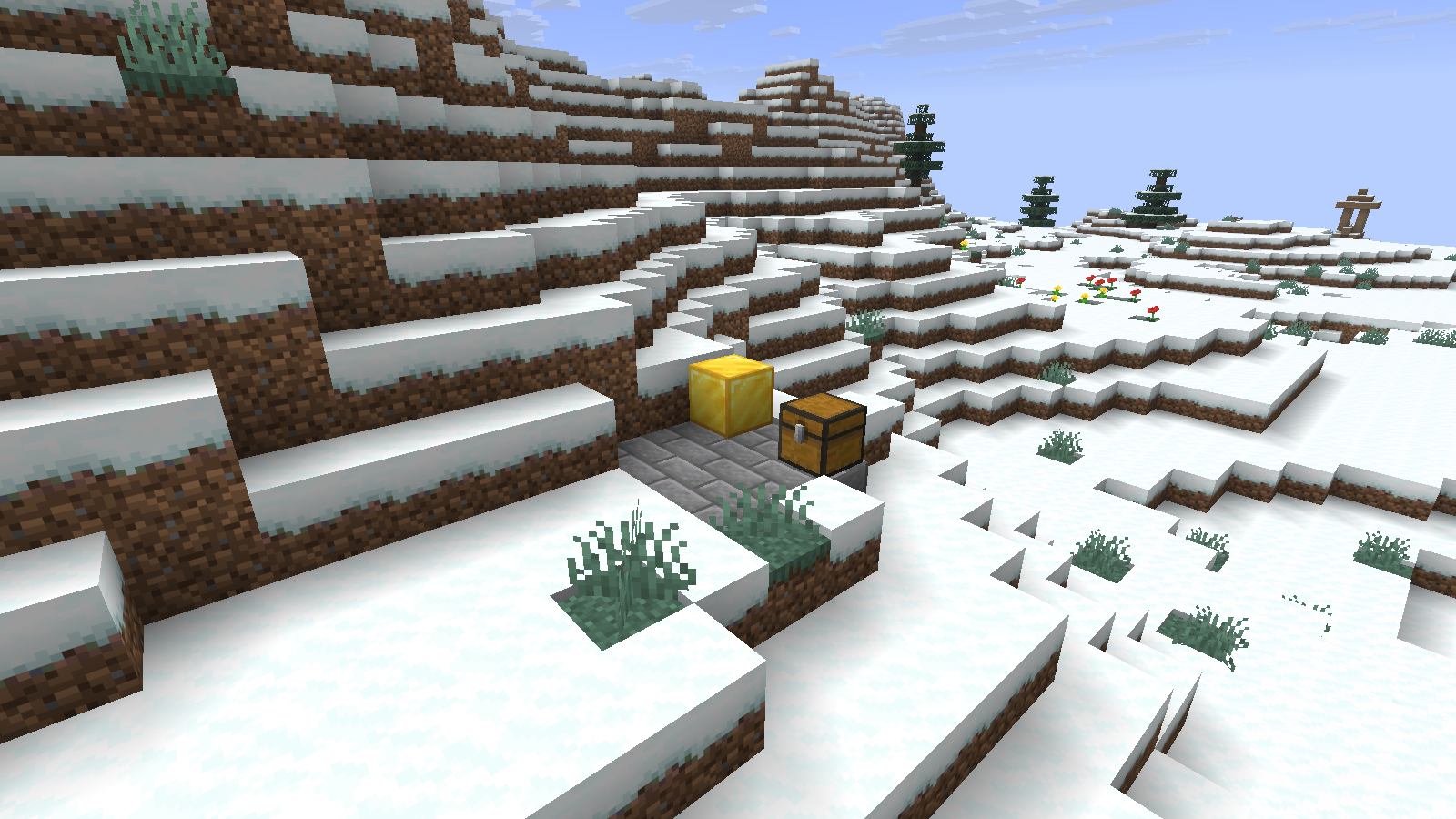 The separately restored world opens with the same gold marker, stone-brick pad and chest on the snowy hillside.