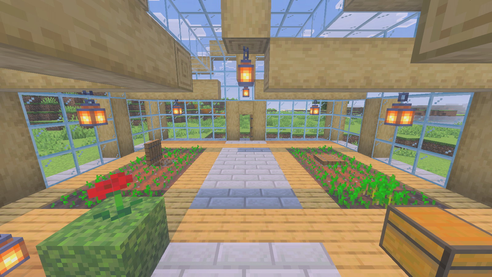 Central paved greenhouse aisle with young wheat beds on either side and lanterns above.
