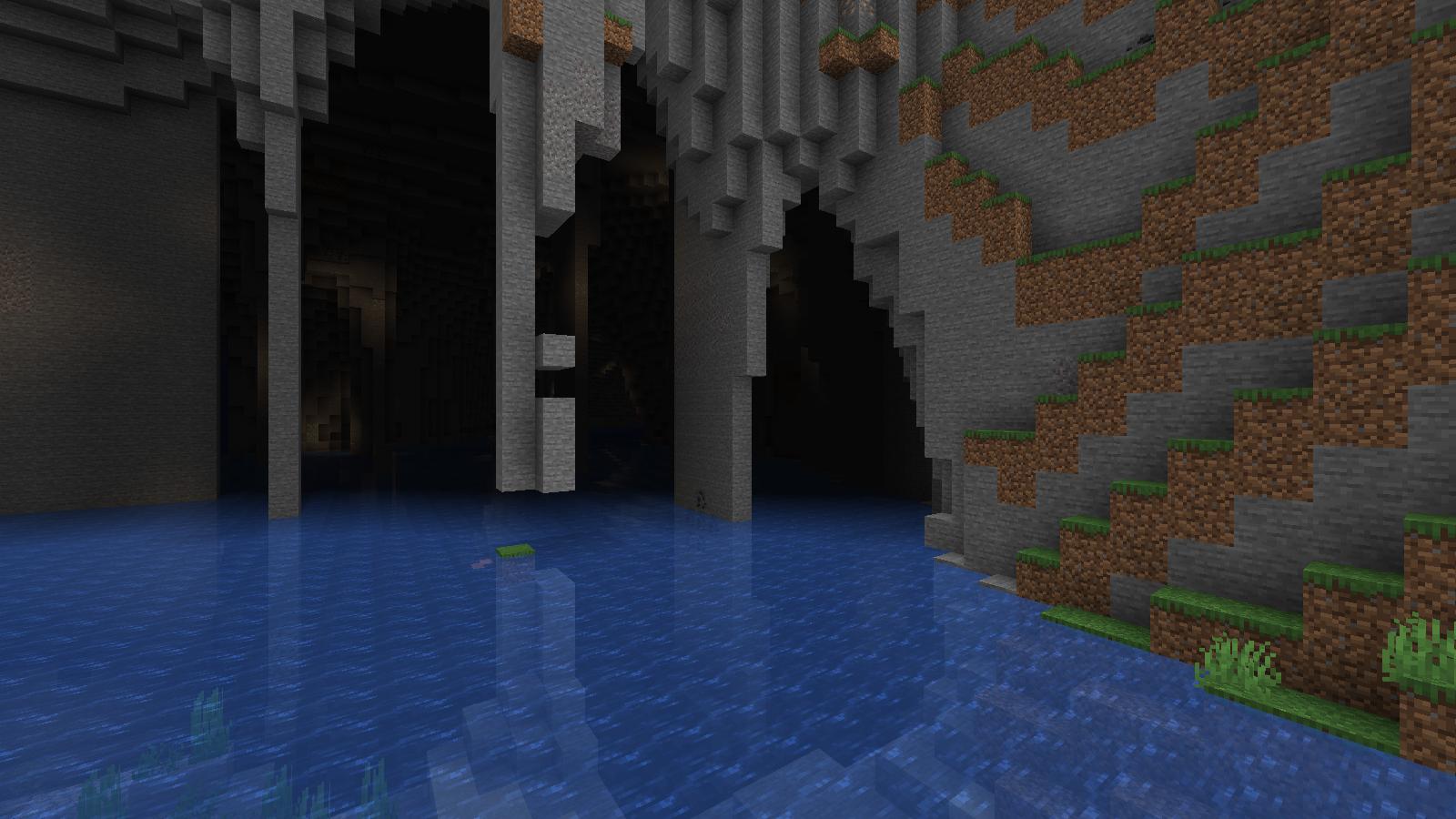 A Tectonic river entering a broad stone opening beneath a grassy mountain slope.