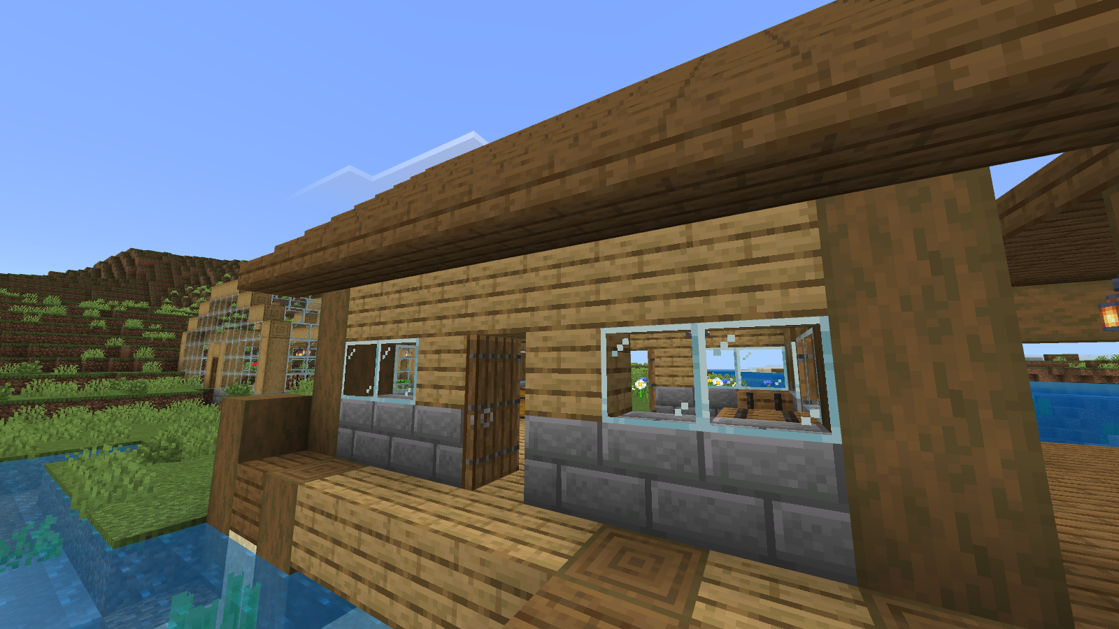 Close default-texture view of the warehouse entrance, window, log supports and stone-brick base.
