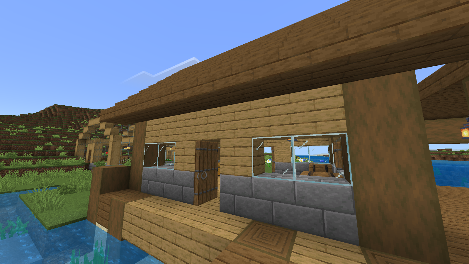 The matching warehouse entrance with Faithful 32x textures on wood, stone bricks and glass.