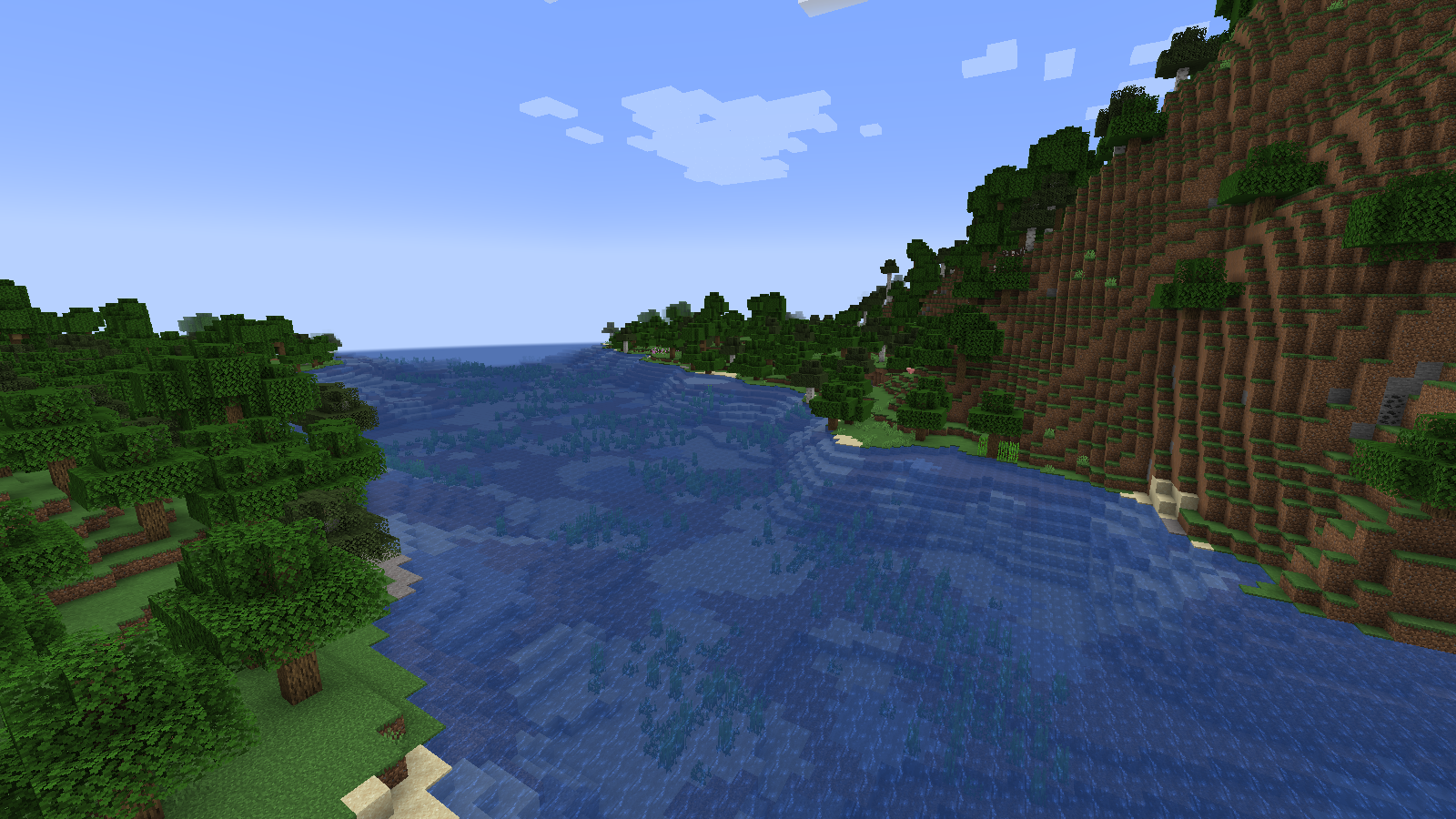 A river between a steep forested cliff and a gentler grassy bank in Tectonic.