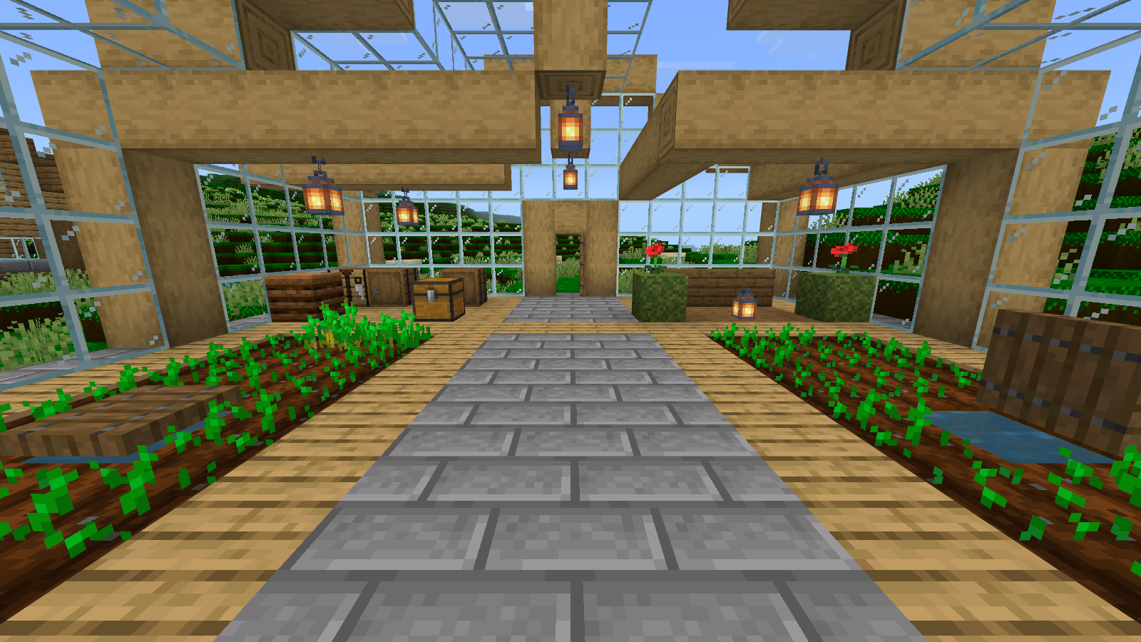 Greenhouse interior with familiar wood and glass and bright green terrain visible through the windows.