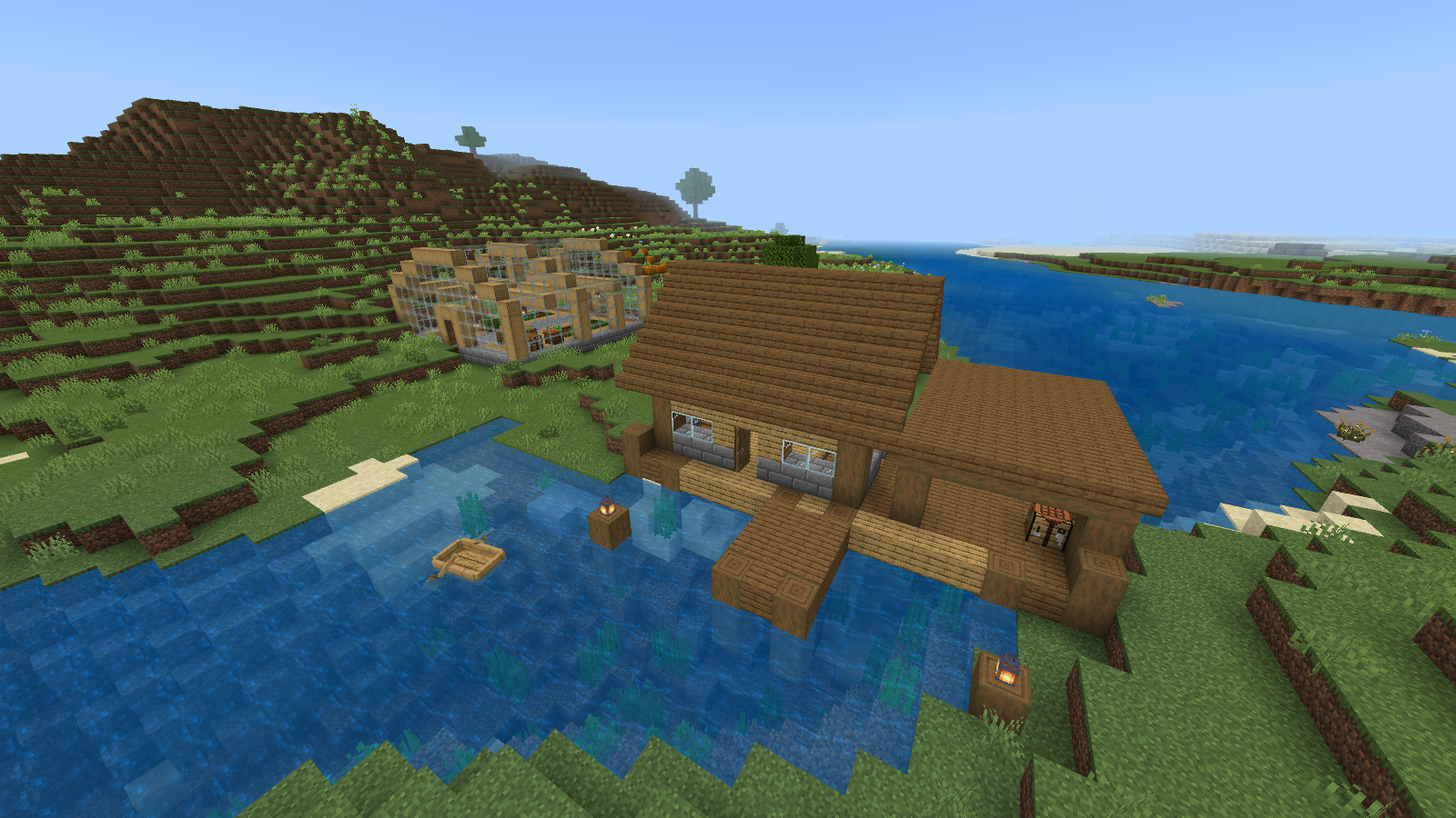 Riverside wooden warehouse, pier and greenhouse in Minecraft's Fancy graphics mode.