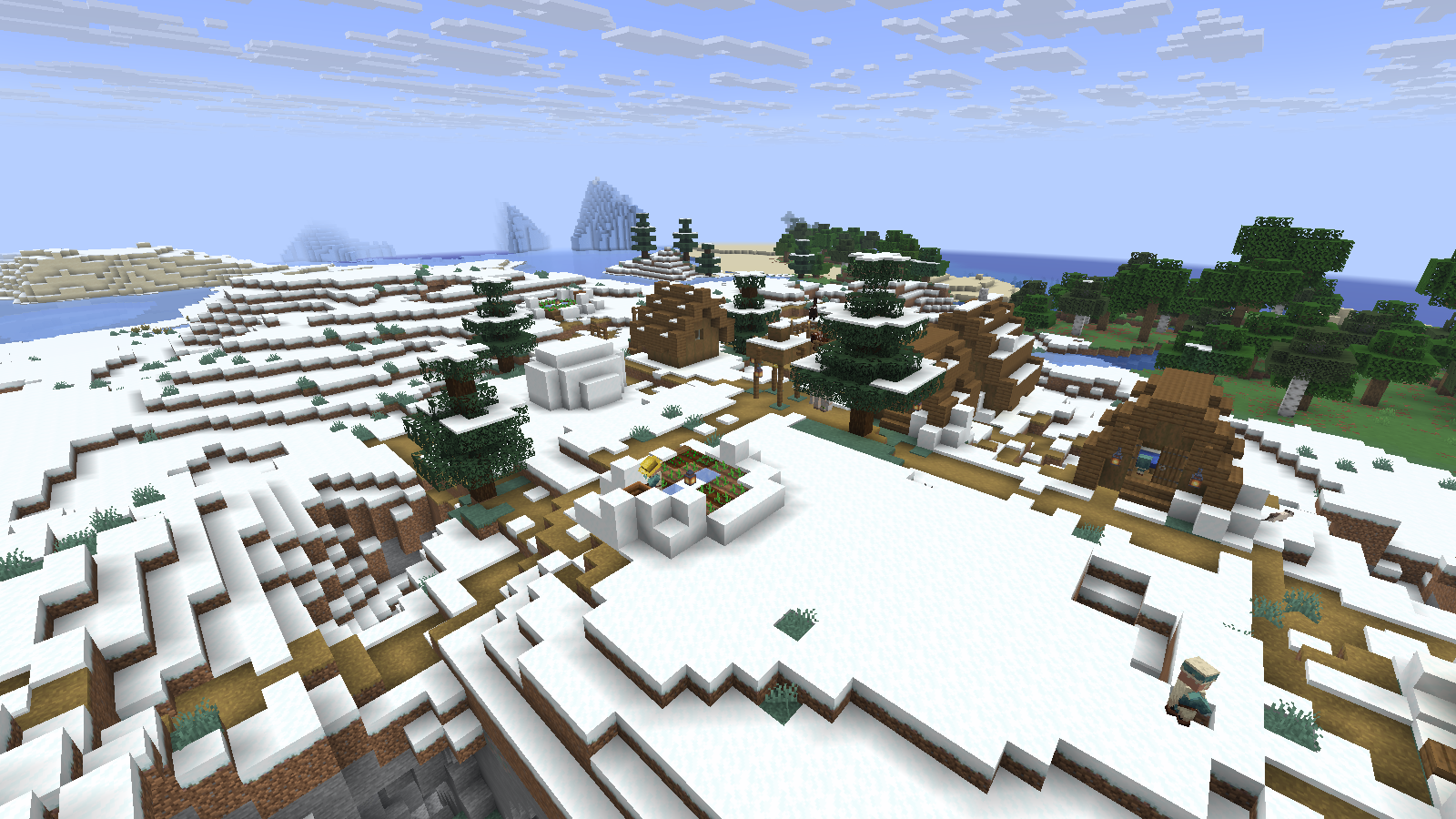 Snowy village houses and paths, with cold coastal water visible behind them. Spectator view in Java 26.2.