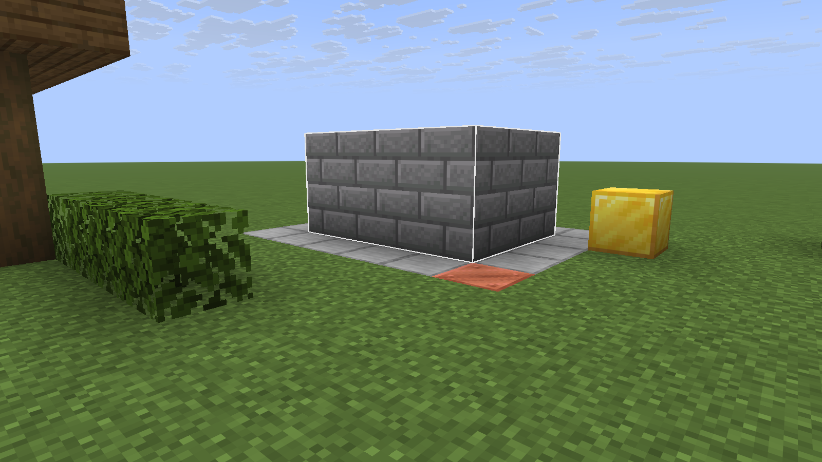The selected volume filled with stone bricks; the gold block sits outside it.