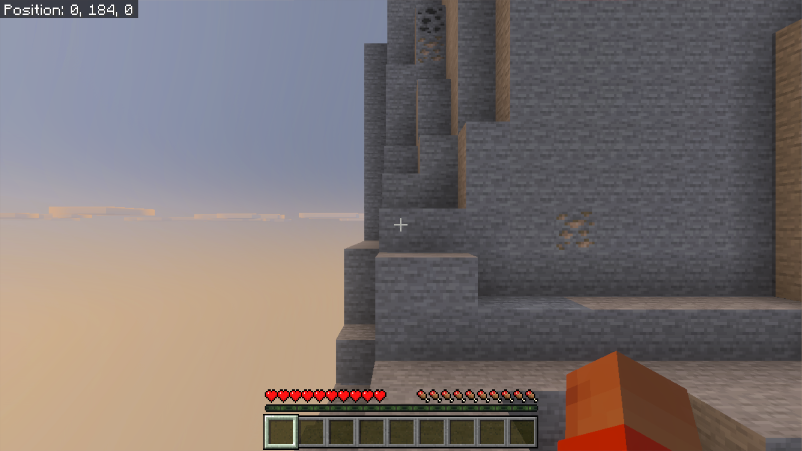 Untouched first-person Bedrock spawn at coordinates 0, 184, 0 on a high stone ledge with coal and iron ore visible.