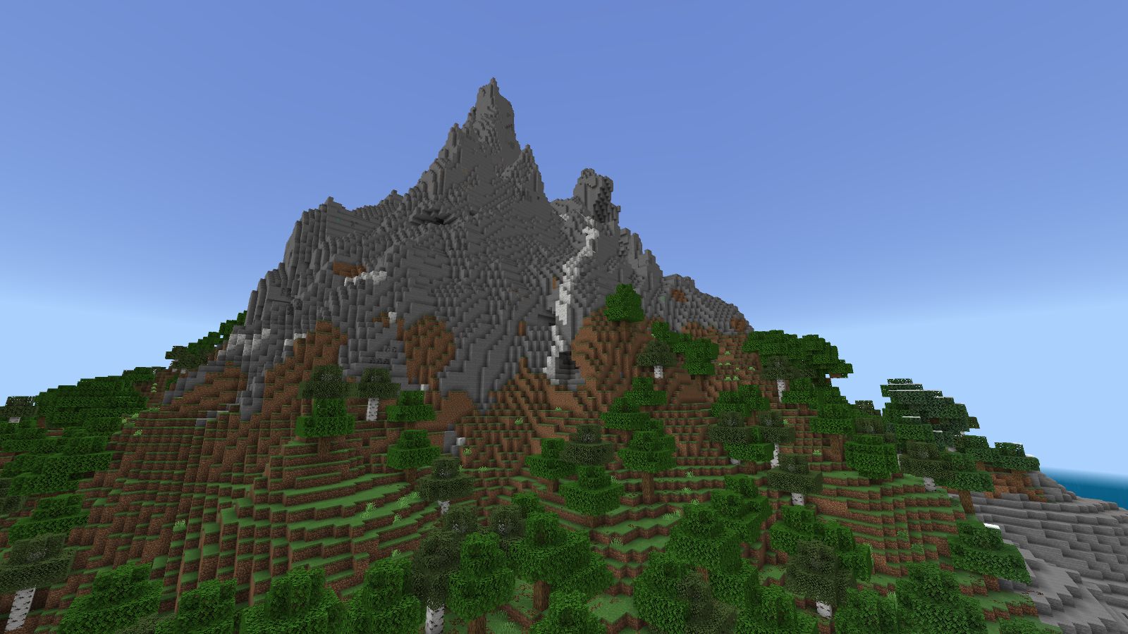 Close native Bedrock view of a stone peak with a white calcite strip, grassy terraces, oak trees and birch trees.