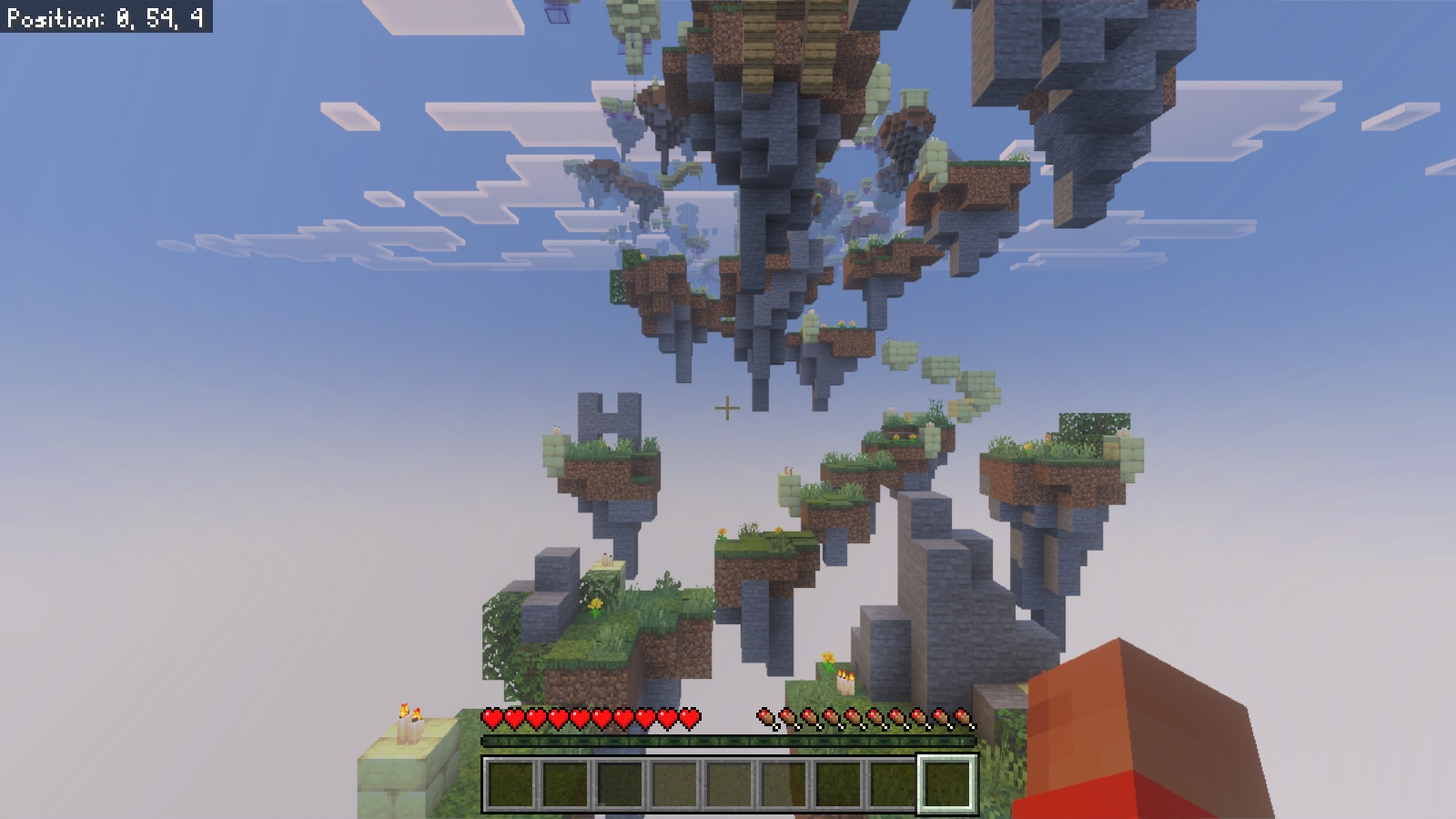 An elevated view over grassy floating platforms and stone ruins after releasing Energy Jump.