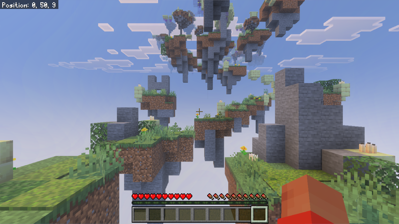 First-person view from a small grassy landing toward the next floating platforms and candle-lit stone ruins.