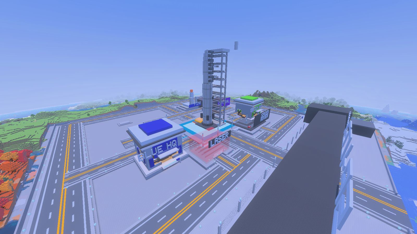 An aerial view of a rocket plaza, blue and green HQ buildings, glass structures and marked roads.