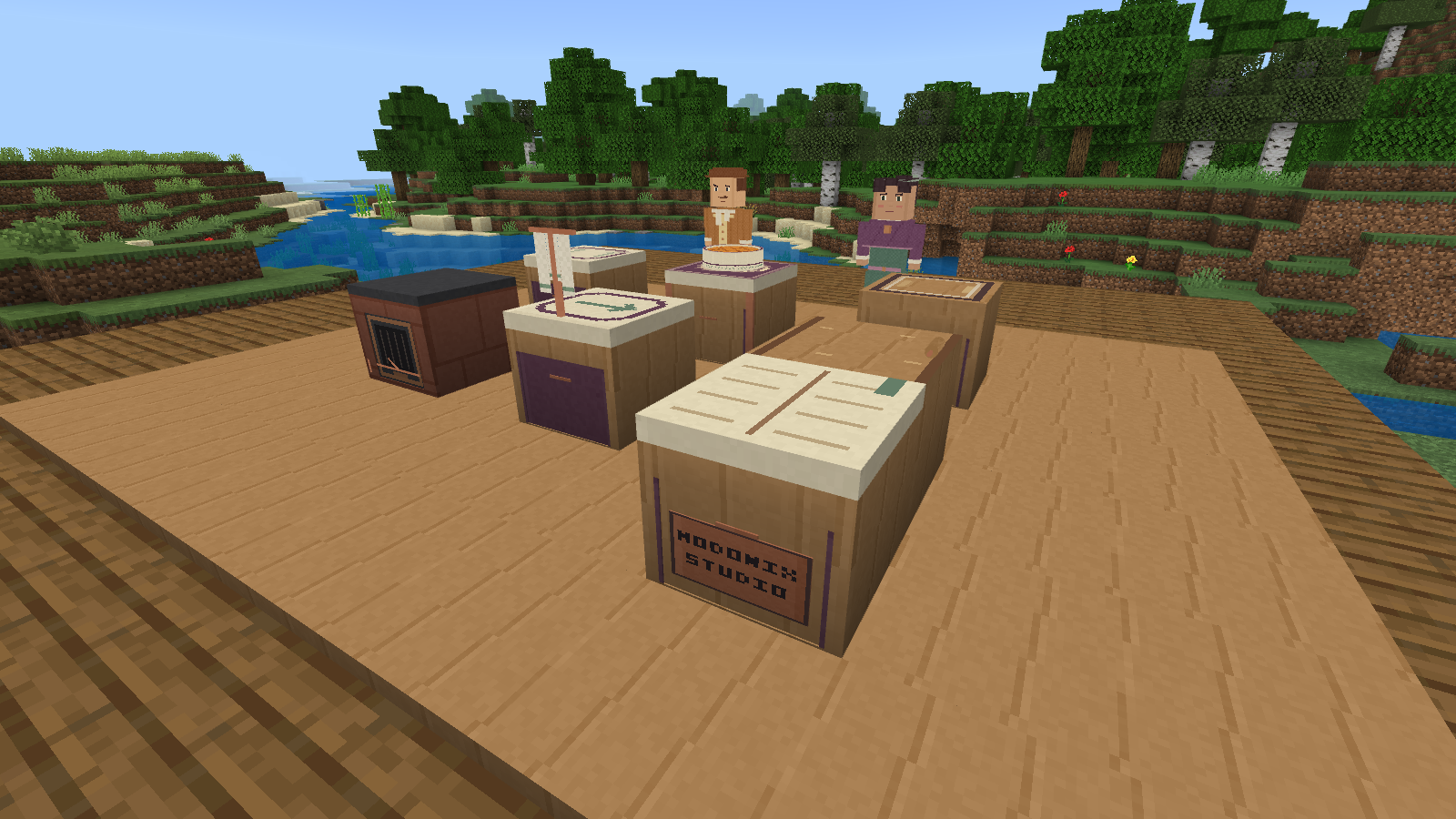 Wooden Fablecrumb kitchen stations beside a Minecraft river, with the unseen cook’s towel, a pie, two guests and a Modonix Studio plaque.