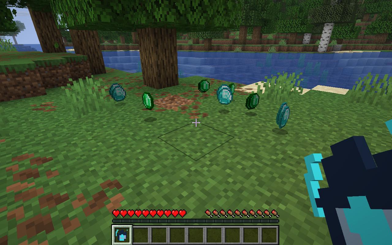 Orbit Gauntlet held beside loose diamonds and emeralds on a Minecraft riverbank before activation