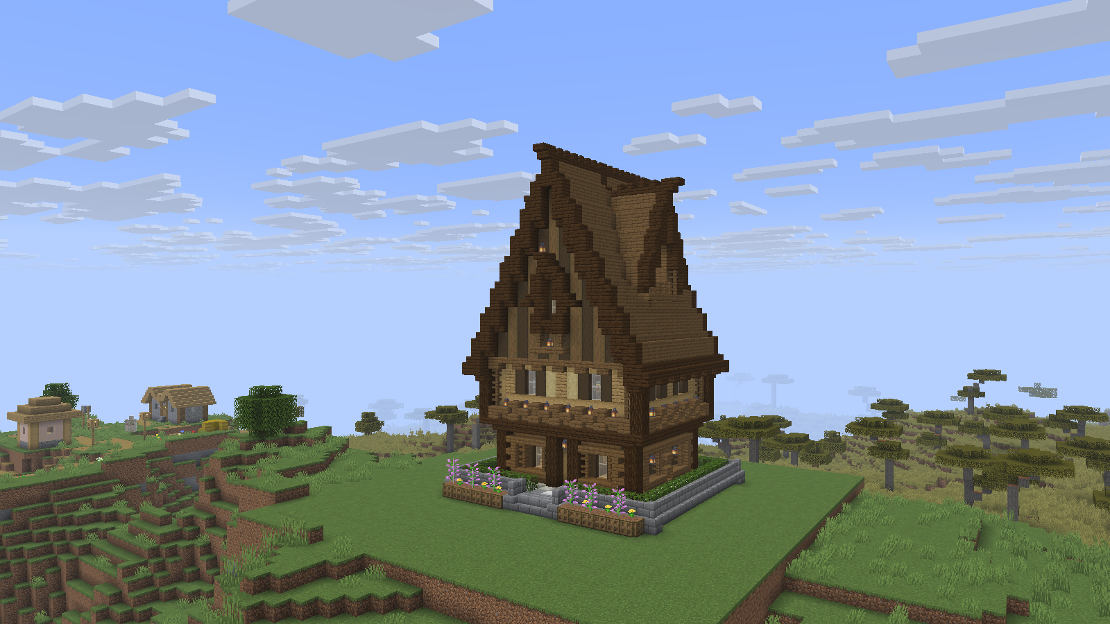 The smallhouse1 schematic placed on a grassy plot, with its tall roof, lanterns and planted details.
