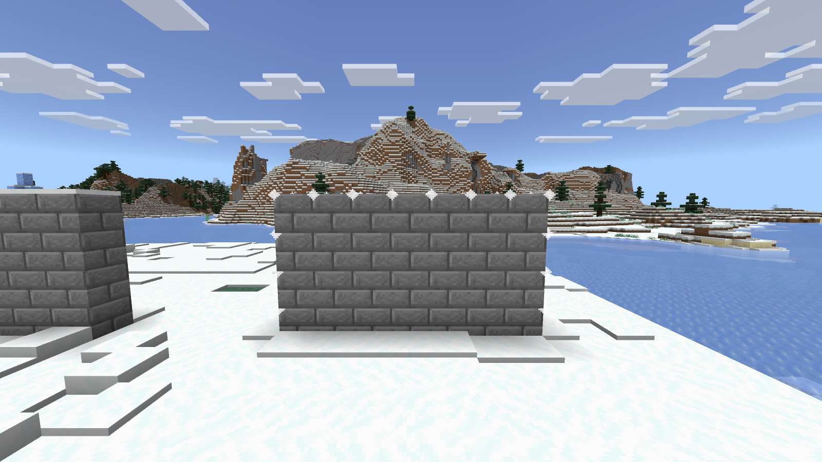 A seven-block-wide stone-brick wall inside WorldEdit’s selection outline in Bedrock.